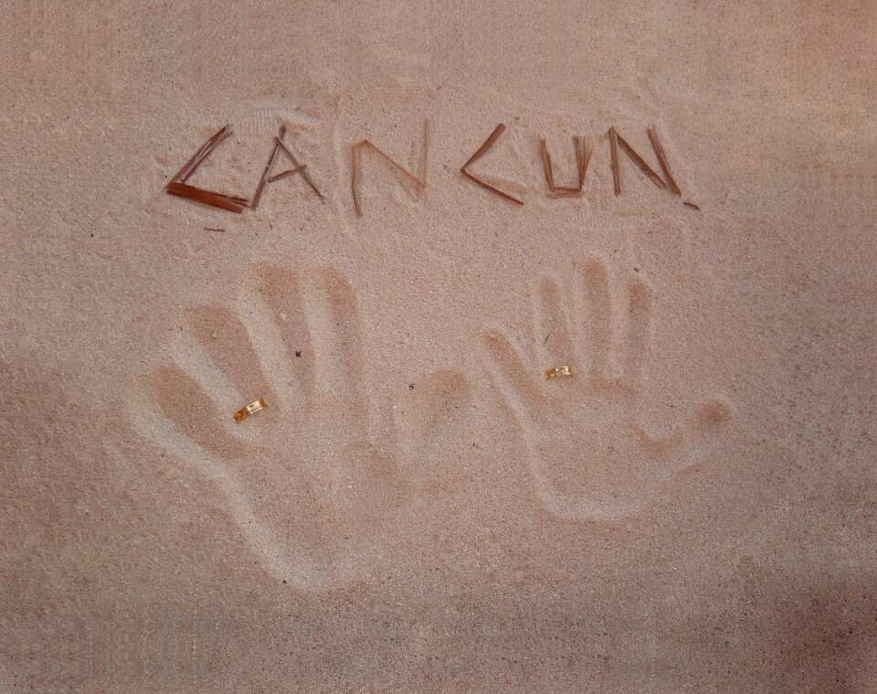 Marriage hands sand