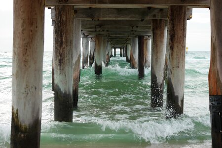 Waves beach wooden pier photo