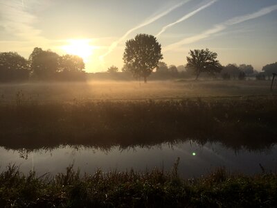 Sun rises water trees