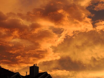 Silhouette orange sky clouds photo