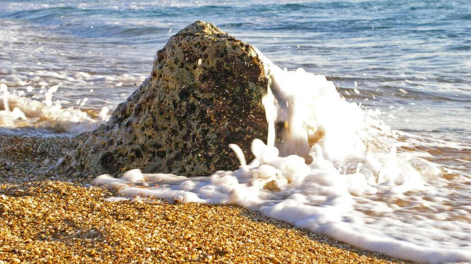 Rock beach sand edge of the sea photo