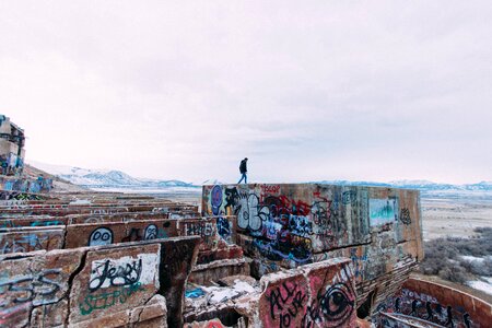 Graffiti walls mountains man walking photo