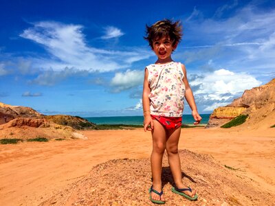 Holidays playing in the sand kid
