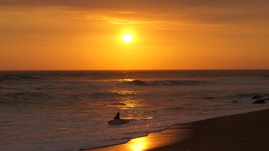 Setting sun beach surf photo