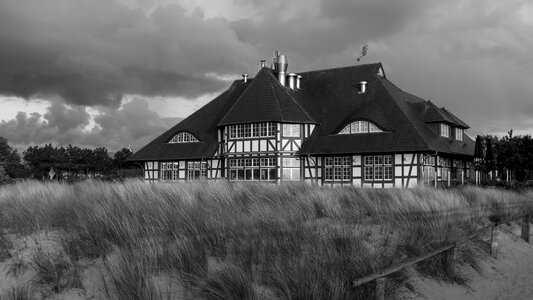 Thatched roof dunes wind photo