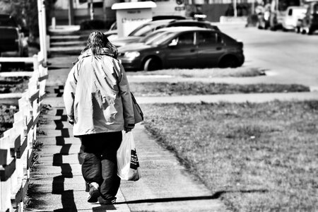 Person black and white walking away