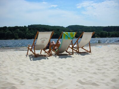 Deck chair lake sand photo