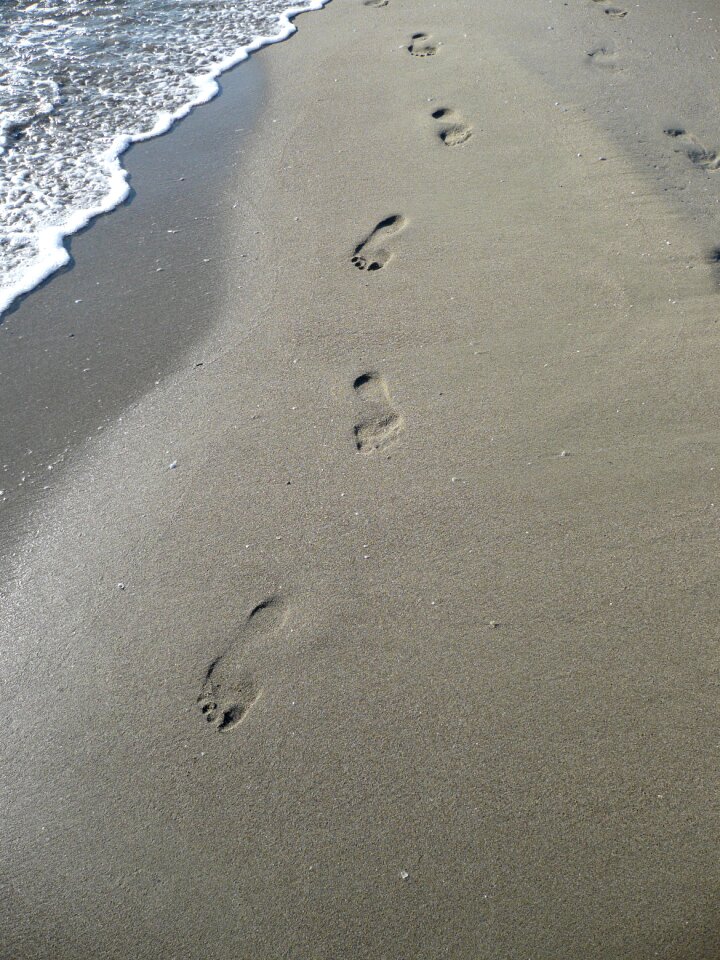 Footprint tracks in the sand sand beach photo