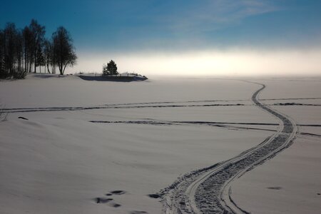 Snowmobile tracks mist winter