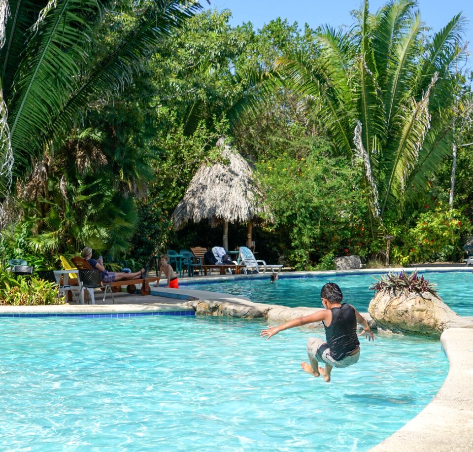 Boy jumping pool bacab jungle park