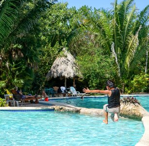 Boy jumping pool bacab jungle park photo