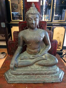 Meditating bronze statue photo