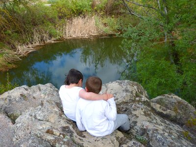 Boy and girl rock pond