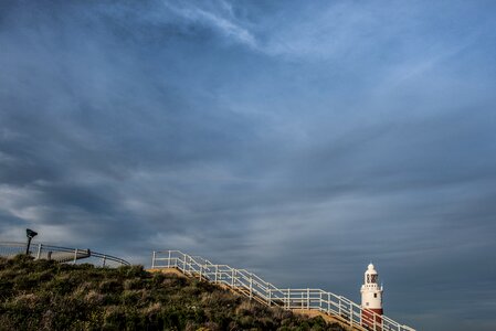 Lighthouse sky clouds photo