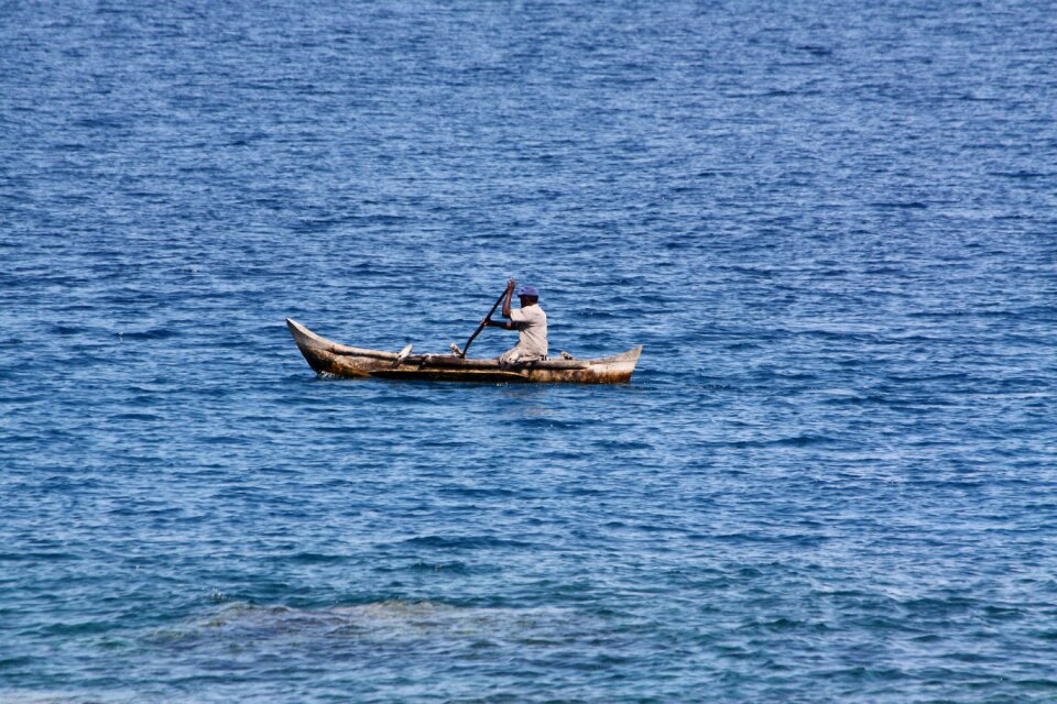 Fisherman sea canoe photo