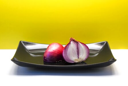 Vegetables black plate yellow background