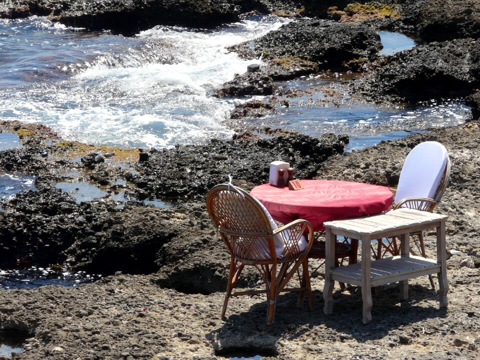 Table on the sea stones rock