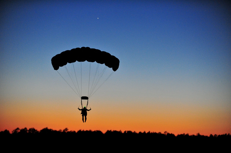 Person gliding sunset