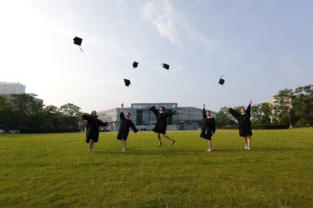 Classmate jump throwing hats