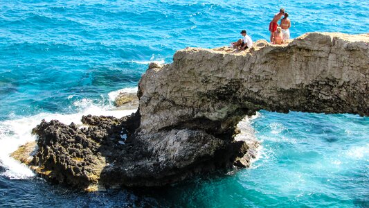 Tourists sightseeing natural arch