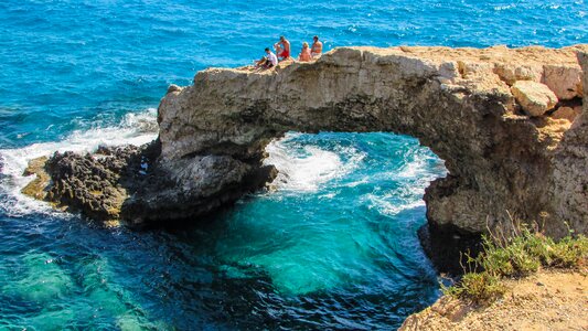 Tourists sightseeing natural arch