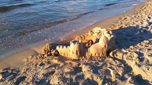 Sand digging baltic sea photo