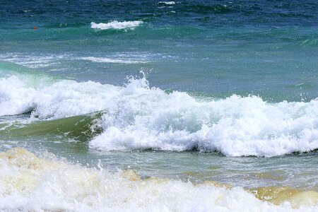 Waves beach spitting water