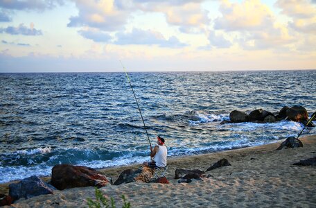 Rocks fisherman sunset photo