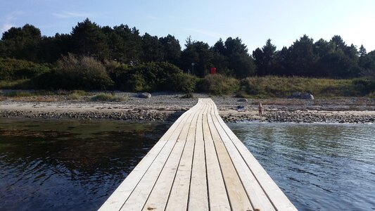 Wooden bridge sandy beach vollerup beach