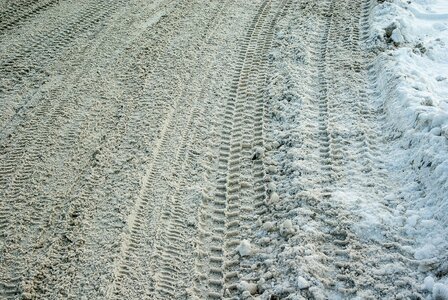 Snow tire tracks icy road photo