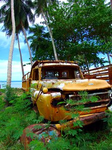 Rusted turned off scrap car photo