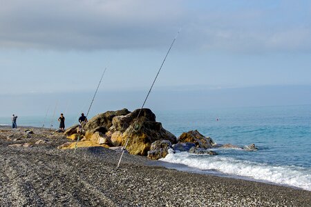 Fishermen beach fishing rods photo