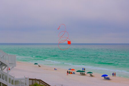 Flying red kite swirly kite photo
