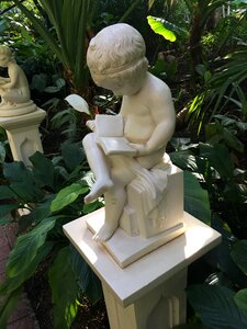 Child reading statue garden photo