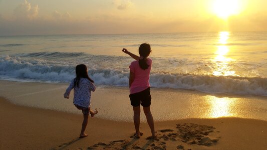 Children sunset wave photo