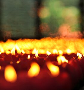 Buddhists lighting candles fire