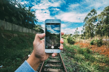 Mobile phone outdoors railroad photo