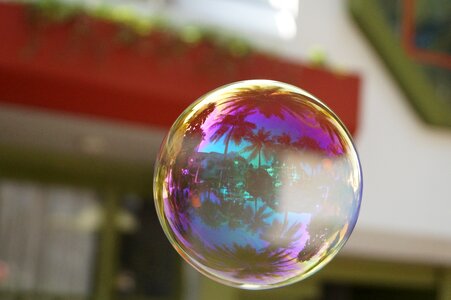 Ball make soap bubbles mirroring photo