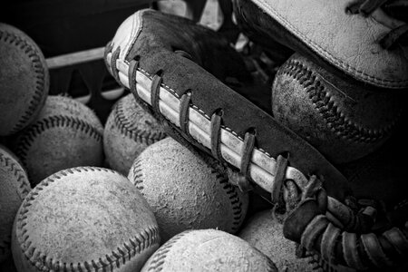 A black and white photo mitt baseball ball and glove