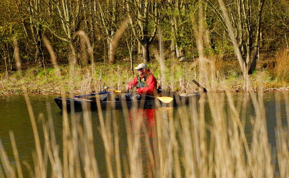 Fisherman kayak reeds photo
