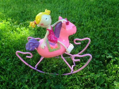 Rocking horse pink pony green grass photo