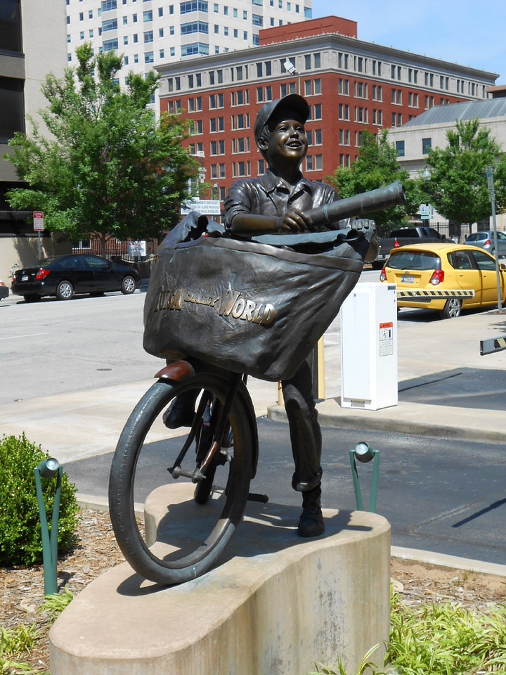 Paper boy statue bicycle