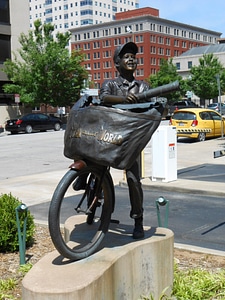Paper boy statue bicycle