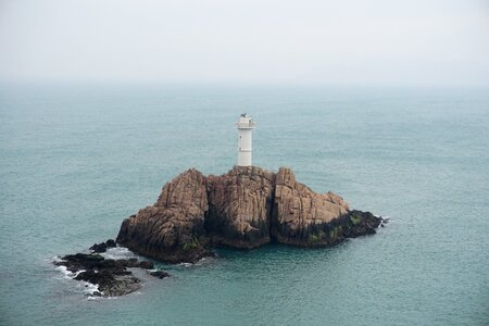 Lighthouse rock sea photo