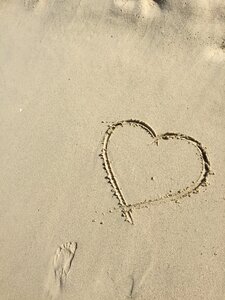 Beach drawing the shape of heart photo