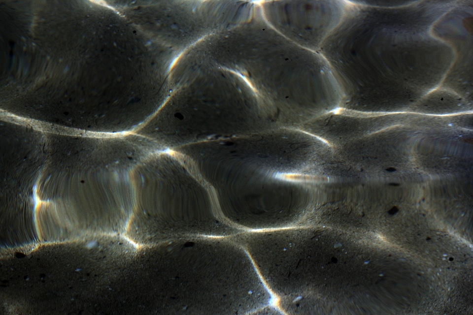 Heart clear water black pebbles