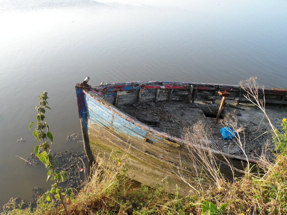 Old boat in need of paint wreck of a boat