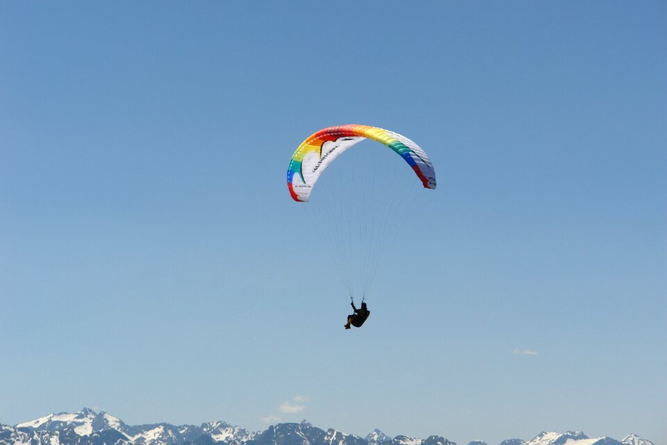 Paraglider mountains sky
