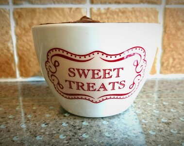 Small white bowl red writing brown writing photo