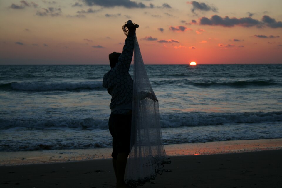 Fisherman sunset sea